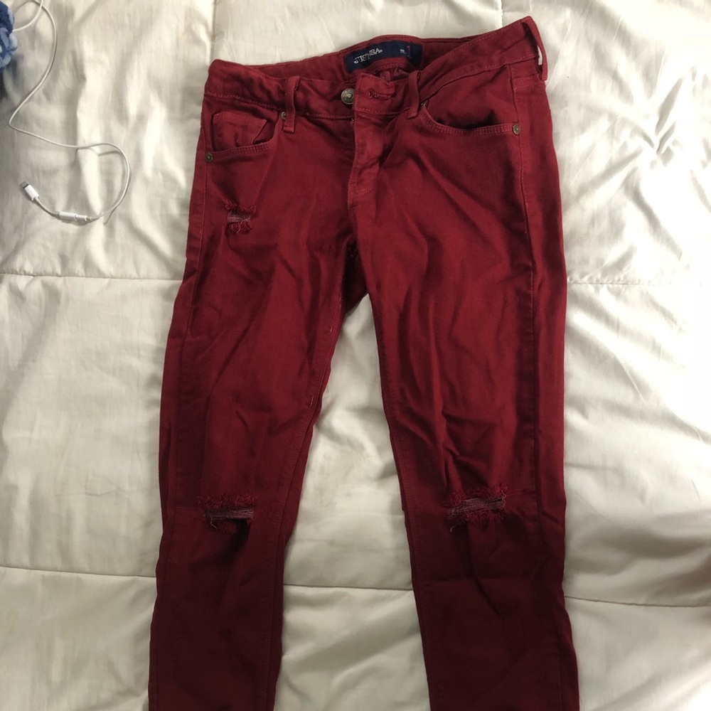 Red distressed skinny jeans